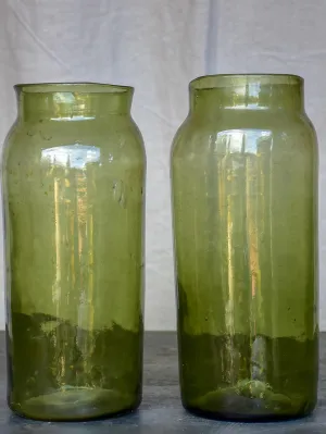 A pair of large late 19th Century green glass jars